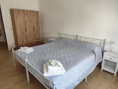 a bedroom with a bed with a blue comforter at da Giò a Trastevere in Rome