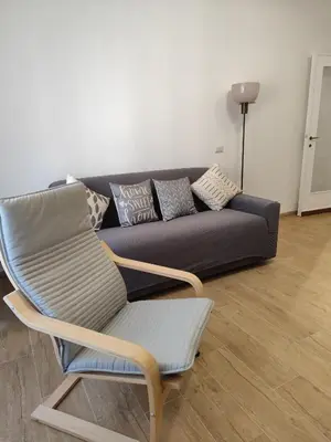a couch and a chair in a living room at da Giò a Trastevere in Rome