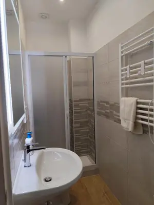 a white bathroom with a sink and a shower at da Giò a Trastevere in Rome