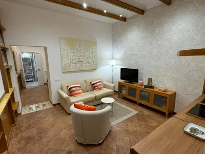 a living room with a couch and a tv at Carrozze apartment in Rome