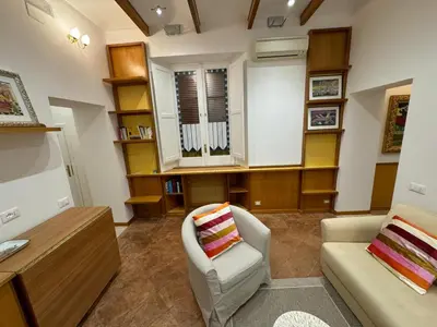 a living room with a couch and a chair at Carrozze apartment in Rome