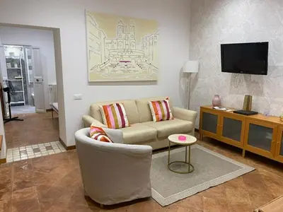 a living room with a couch and a tv at Carrozze apartment in Rome