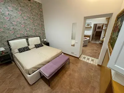 a small bedroom with a bed and a bathroom at Carrozze apartment in Rome