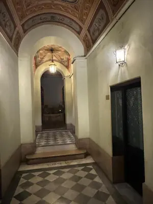 a hallway of a building with a ceiling at Carrozze apartment in Rome