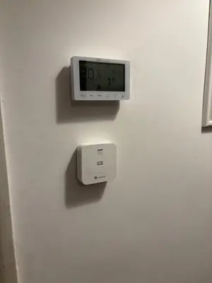 a clock on a white wall with a alarm clock at Alla Pineta in Rome