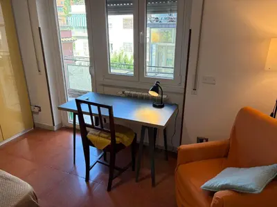 a table and chair in a room with a window at Alla Pineta in Rome