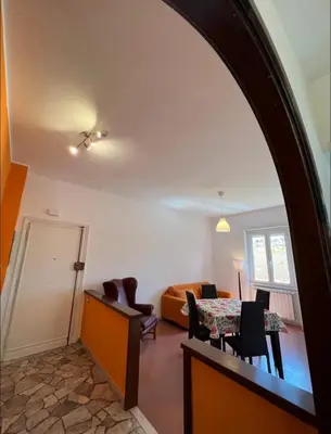 a living room with a table and a couch at Alla Pineta in Rome