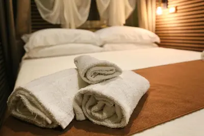 a towel sitting on top of a bed at I Quattro Elementi Roma in Rome