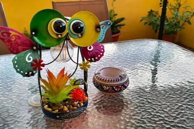 a table with a vase filled with balloons and a plant at A Casa di Cri in Rome