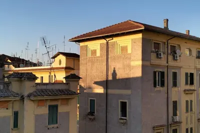 a tall building with a shadow on the side of it at A Casa di Cri in Rome