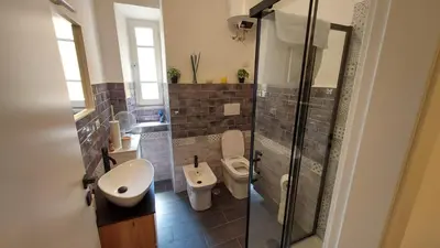 a bathroom with a toilet and a sink and a shower at A Casa di Cri in Rome
