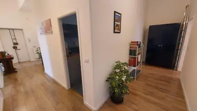 a room with a potted plant and a hallway at A Casa di Cri in Rome