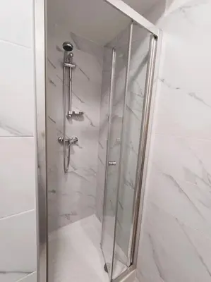 a shower with a glass door in a bathroom at Pi gneto GH Locazione Turistica in Rome