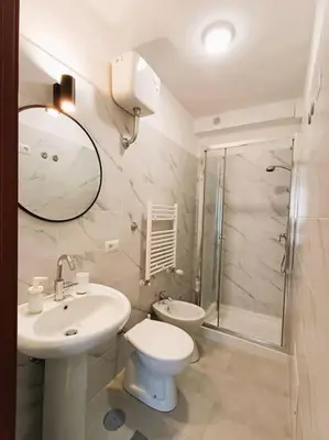 a bathroom with a sink and a toilet and a shower at Pi gneto GH Locazione Turistica in Rome