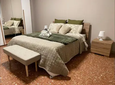 a bedroom with a bed and a chair and a mirror at Fuffy House Rome in Rome