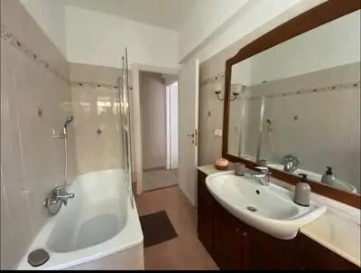 a bathroom with a sink and a tub and a mirror at Fuffy House Rome in Rome