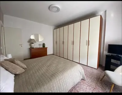 a bedroom with a large bed and a television at Fuffy House Rome in Rome