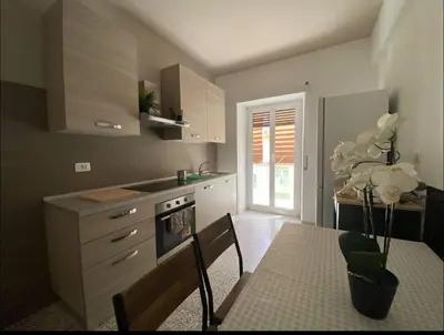 a kitchen with a table and a stove top oven at Fuffy House Rome in Rome