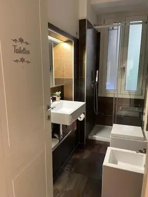 a bathroom with two sinks and a shower at PiazzaBolognaStay in Rome