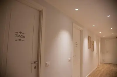 a hallway with a door with a sign on the wall at PiazzaBolognaStay in Rome