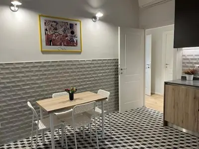a kitchen with a table and chairs in a room at PiazzaBolognaStay in Rome