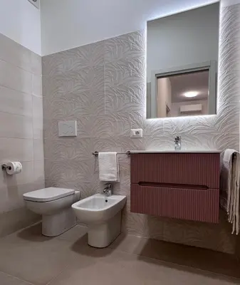 a bathroom with a toilet and a sink and a mirror at Dasy Apartment - San Paolo in Rome
