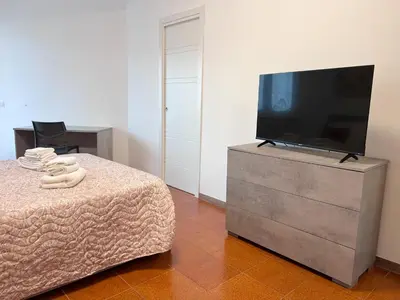 a bedroom with a flat screen tv on a dresser at Dasy Apartment - San Paolo in Rome