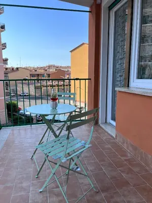 a table and a chair on a balcony at Dasy Apartment - San Paolo in Rome