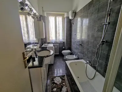 a bathroom with two sinks and a tub and two toilets at Double- Room Basilica San Paolo in Rome