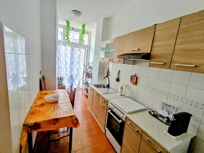 a kitchen with a wooden table and a counter top at Double- Room Basilica San Paolo in Rome