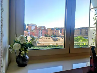 a vase with white flowers sitting on a window sill at Double- Room Basilica San Paolo in Rome