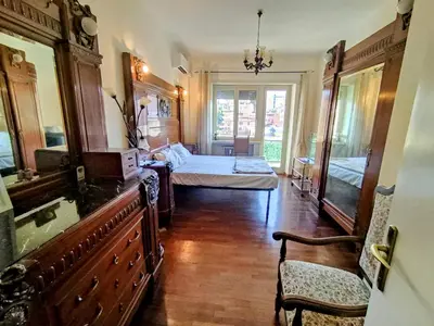a large room with a bed and a dresser and a bedroom at Double- Room Basilica San Paolo in Rome
