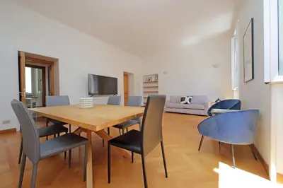 a dining room with a wooden table and chairs at Appartamento 