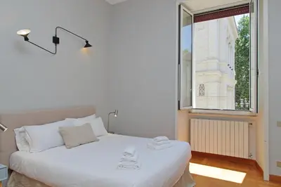 a white bed in a room with a window at Appartamento 