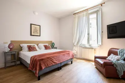 a bedroom with a bed and a couch at Casa Marchese Lucia in Rome