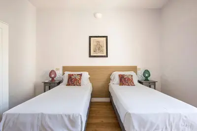 two beds in a room with white walls at Casa Marchese Lucia in Rome