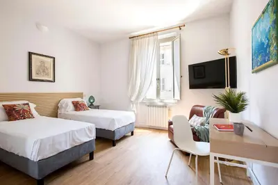 a hotel room with two beds and a tv at Casa Marchese Lucia in Rome