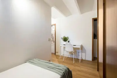 a bedroom with a bed and a table and a chair at Casa Marchese Lucia in Rome