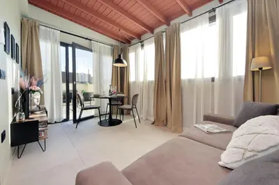 a living room with a couch and a table at 100m dal Vaticano Oasi Luxury 2 Terraces in Rome