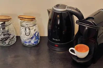 a coffee maker and two mason jars on a counter at 100m dal Vaticano Oasi Luxury 2 Terraces in Rome