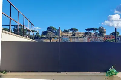 a large black wall with a city in the background at 100m dal Vaticano Oasi Luxury 2 Terraces in Rome