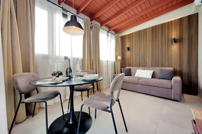 a living room with a table and chairs and a couch at 100m dal Vaticano Oasi Luxury 2 Terraces in Rome