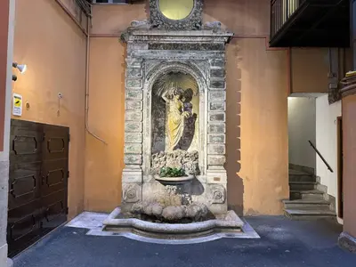a statue of a woman on the side of a building at Mercede Apartment - Spanish Steps in Rome
