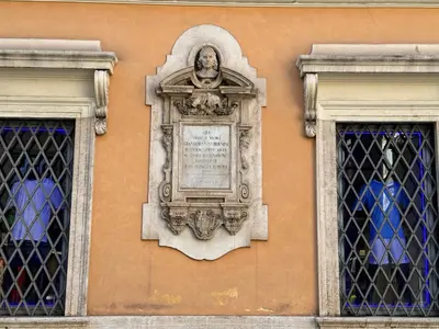 a plaque on the side of a building with two windows at Mercede Apartment - Spanish Steps in Rome