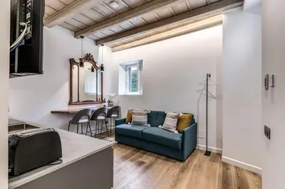 a living room with a blue couch and chairs at Piazza dei Renzi Trastevere building 4 bedroom with terrace in Rome