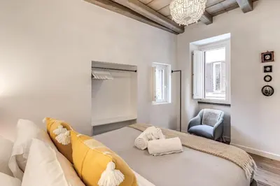 a living room with a couch and a chair at Piazza dei Renzi Trastevere building 4 bedroom with terrace in Rome