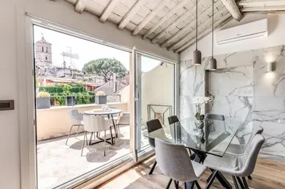a dining room with a glass table and chairs at Piazza dei Renzi Trastevere building 4 bedroom with terrace in Rome
