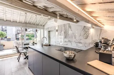a kitchen with a counter top and a table at Piazza dei Renzi Trastevere building 4 bedroom with terrace in Rome