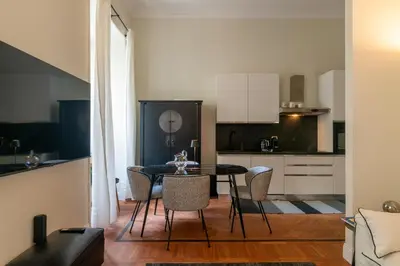 a kitchen and dining room with a table and chairs at Villa Borghese Luxury Place in Rome