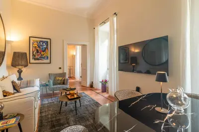 a living room with a bed and a couch at Villa Borghese Luxury Place in Rome